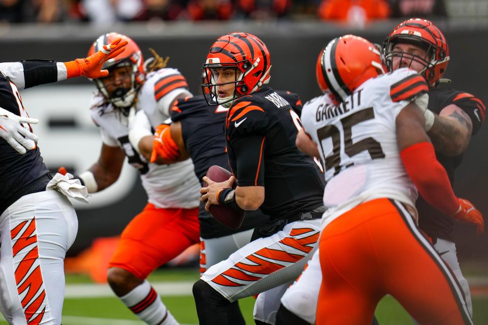 Cincinnati Bengals quarterback Joe Burrow (9) protects the ball in the pocket under pressure from Cleveland Browns defensive end Myles Garrett (95) in the second quarter of the NFL Week 14 game between the Cincinnati Bengals and the Cleveland Browns at Paycor Stadium in Cincinnati on Sunday, Dec. 11, 2022. The Bengals led 13-3 at halftime.

Cleveland Browns At Cincinnati Bengals Week 14