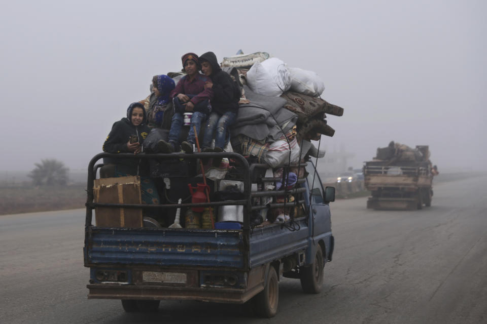 Civilians ride in a truck as they flee Maaret al-Numan, Syria, ahead of a government offensive, Monday, Dec. 23, 2019. (AP Photo/Ghaith al-Sayed)