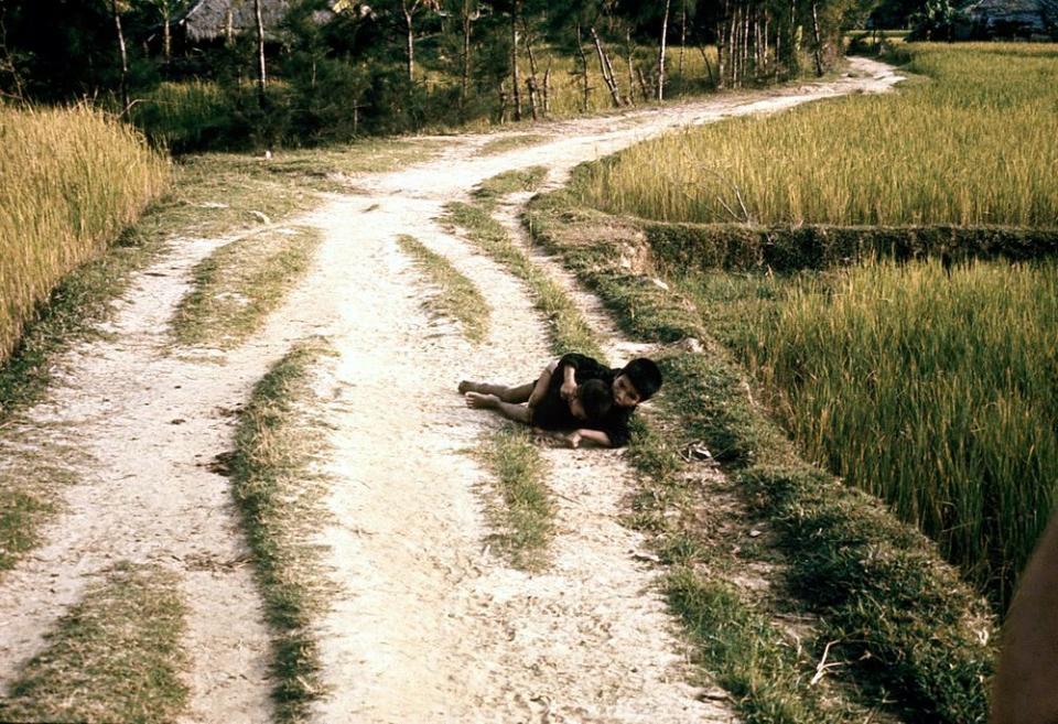Two Vietnamese children on a road before they were shot by U.S. soldiers on March 16, 1968.