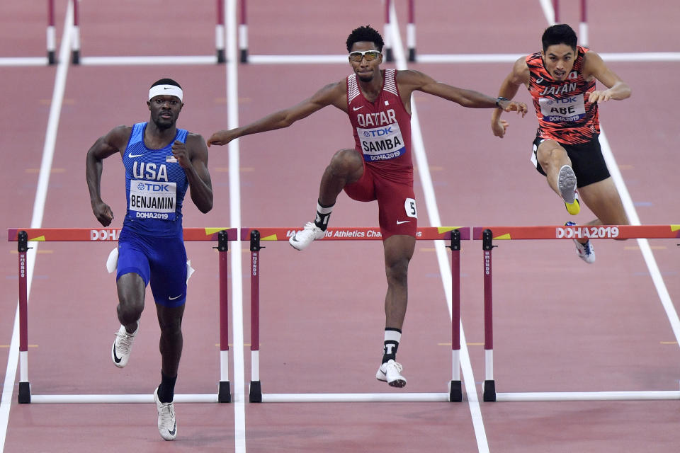 Rai Benjamin, of the United States, Abderrahman Samba, of Qatar, and Takatoshi Abe, of Japan, from left, compete in a men's 400 meter hurdles race semifinal during the World Athletics Championships in Doha, Qatar, Saturday, Sept. 28, 2019. (AP Photo/Martin Meissner)