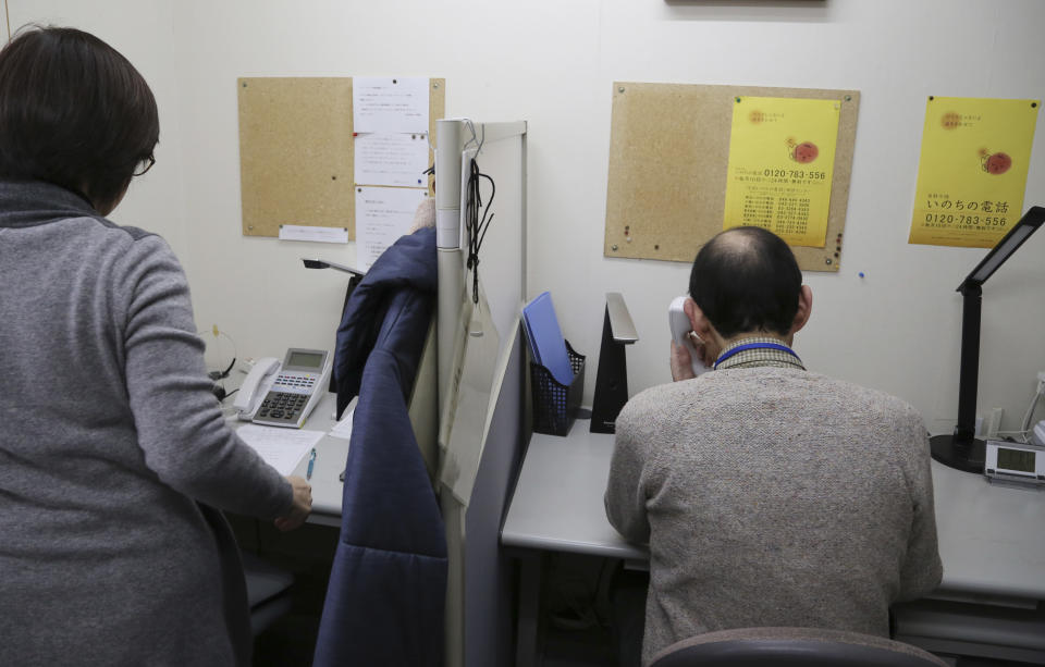 In this March 15, 2017 photo, Shinjiro Shishido, director of "Inochinodenwa," non-profit telephone hotline for people seek help, receives a counseling call in Tokyo. Fewer Japanese are taking their own lives, a glimmer of hope in a country with one of the world’s highest suicide rates. The number of suicides has dropped for seven straight years in a clear indication of a downward trend. The Health Ministry said Thursday, March 23, 2017, that 21,897 people committed suicide in 2016, down from more than 30,000 in 2011. (AP Photo/Koji Sasahara)