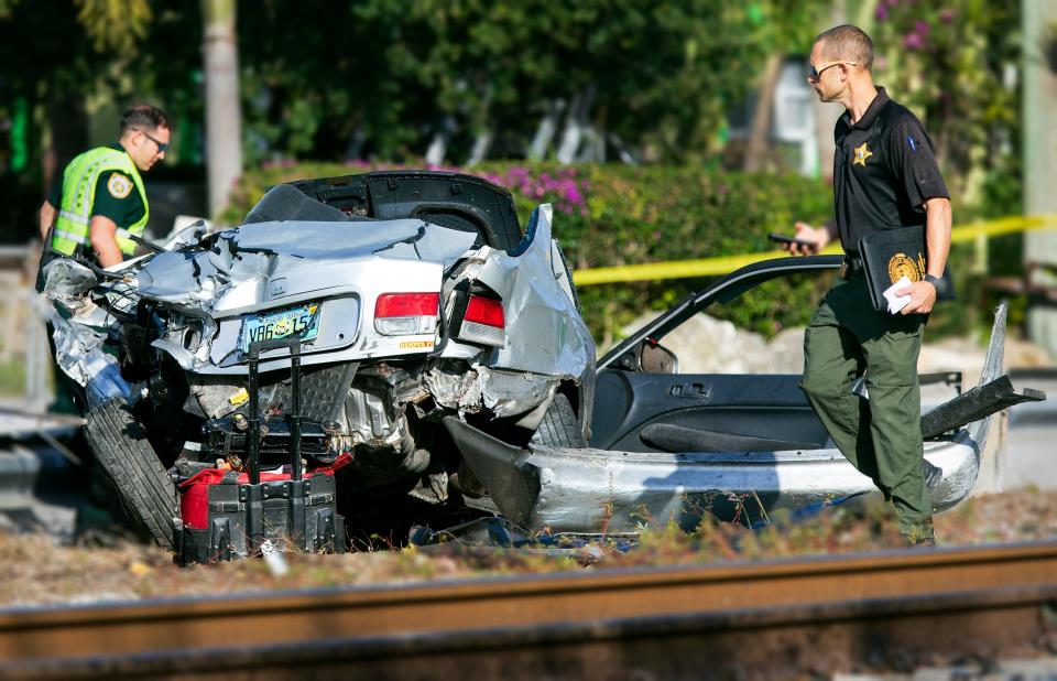 Deputies examine the scene after a Brightline passenger train hit a car early morning in Lake Worth Beach Wednesday, February 16, 2022. It was the third time in four days Brightline hit a vehicle in Palm Beach County. The wreck happened shortly before 6:30 a.m. just south of Washington Avenue near Dixie Highway in Lake Worth Beach. 