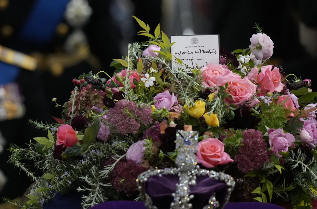 A note rests atop a flower arrangement on top of the coffin of Queen Elizabeth II as it is carried out of Westminster Abbey during the Ceremonial Procession for the State Funeral of Queen Elizabeth II, held at Westminster Abbey, London. Picture date: Monday September 19, 2022.