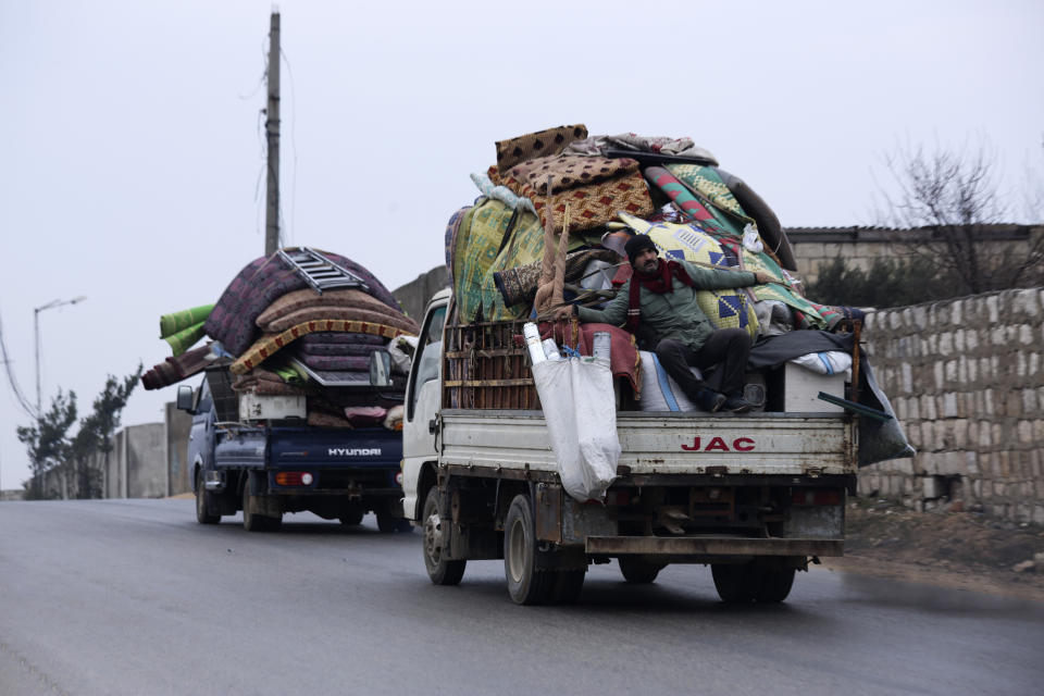 Syrians drive through the city of al-Mastouma, in Idlib province, as they flee a government offensive, Tuesday, Jan. 28, 2020. Syrian government forces have been on the offensive for more than a month in the northwestern Idlib province, the last rebel stronghold in the country. But in recent days, the government captured more than a dozen villages in the area as the insurgents' defenses began to crumble. (AP Photo/Ghaith Alsayed)