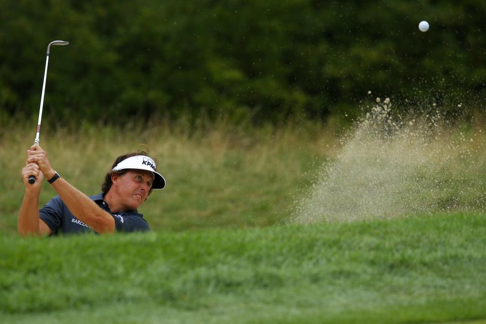 Mickelson of the U.S. hits out of the bunker on the first hole during the Deutsche Bank Championship golf tournament in Norton