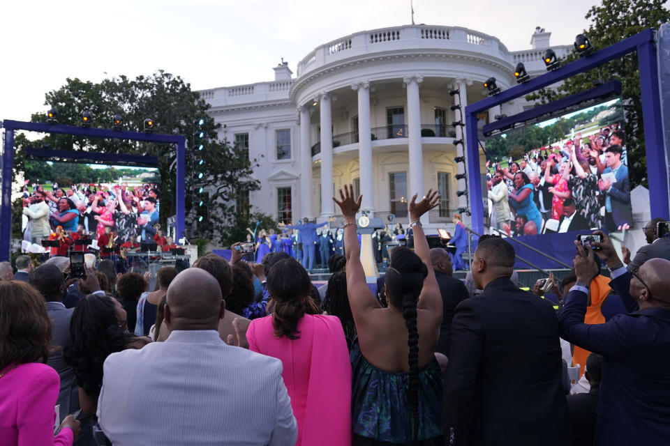 Guests respond as Broadway Inspirational Voices performs during a Juneteenth concert on the South Lawn of the White House in Washington, Tuesday, June 13, 2023. (AP Photo/Susan Walsh)
