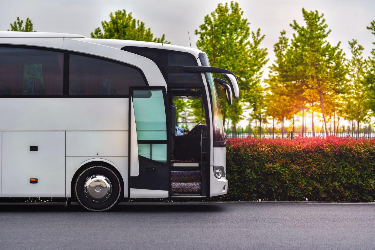 travel company bus greets tourists at the airport to take to the hotel