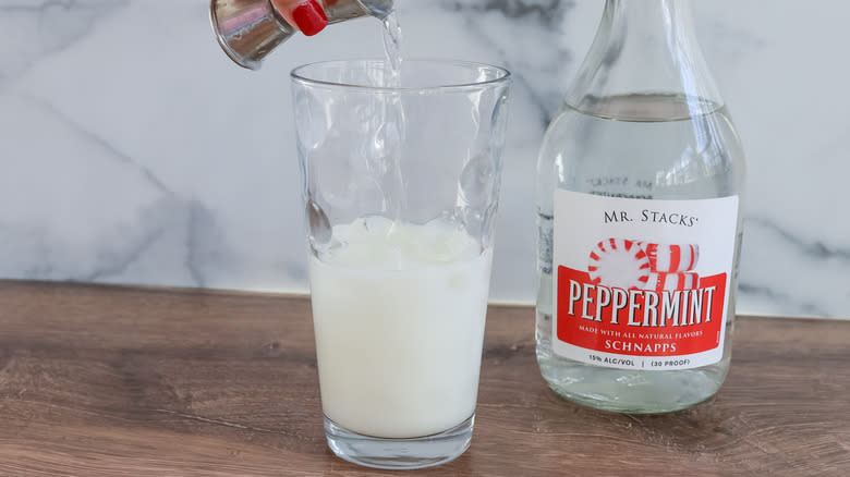 pouring peppermint schnapps into glass
