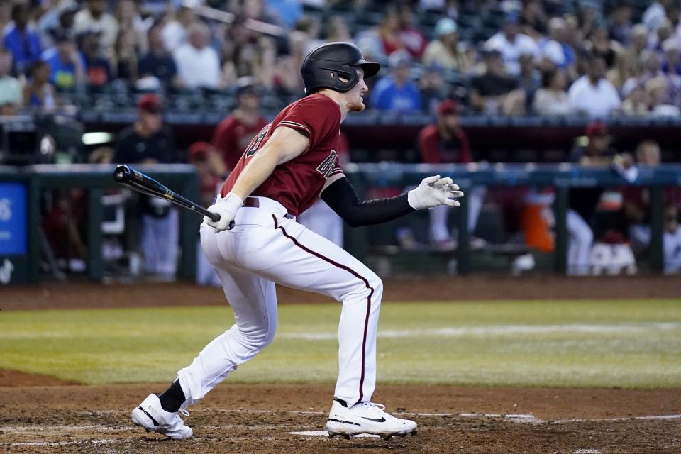 Arizona Diamondbacks' Pavin Smith watches his two-run single against the Detroit Tigers during the fourth inning of a baseball game Sunday, June 26, 2022, in Phoenix. (AP Photo/Ross D. Franklin)