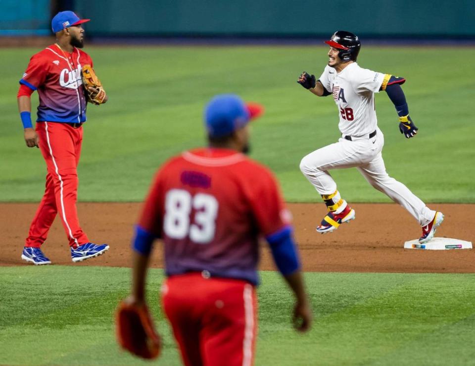 USA infielder Nolan Arenado (28) triples on a line drive to right field against Cuba during the fourth inning of a semifinal game at the World Baseball Classic at loanDepot Park on Sunday, March 19, 2023, in Miami, Fla.