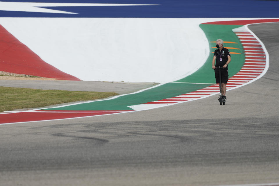 A Mercedes crew member rides the course before the Formula One U.S. Grand Prix auto race at the Circuit of the Americas, Thursday, Oct. 21, 2021, in Austin, Texas. (AP Photo/Nick Didlick)