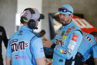 NASCAR driver Kyle Busch talks with a member of his crew after he qualified the NASCAR Brickyard 400 auto race at the Indianapolis Motor Speedway, Sunday, Sept. 8, 2019, in Indianapolis. (AP Photo/Darron Cummings)