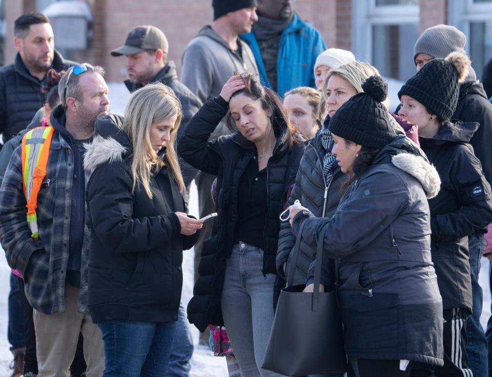 Parents wait for news after a bus crashed into a daycare centre in Laval, Quebec, on Wednesday, Feb. 8, 2023 (AP)
