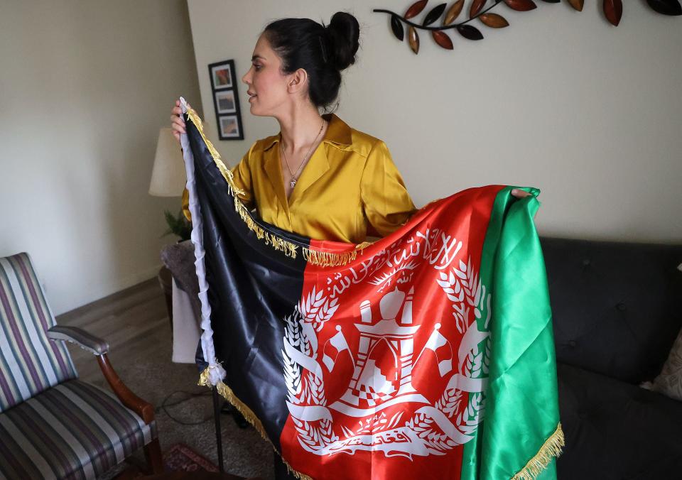 Crystal Bayat, an Afghan social activist, human rights advocate and founder of the Crystal Bayat Foundation, shows the former flag of Afghanistan, which is now seen as a symbol of resistance against the Taliban, at home in West Jordan on Wednesday, June 28, 2023. | Kristin Murphy, Deseret News