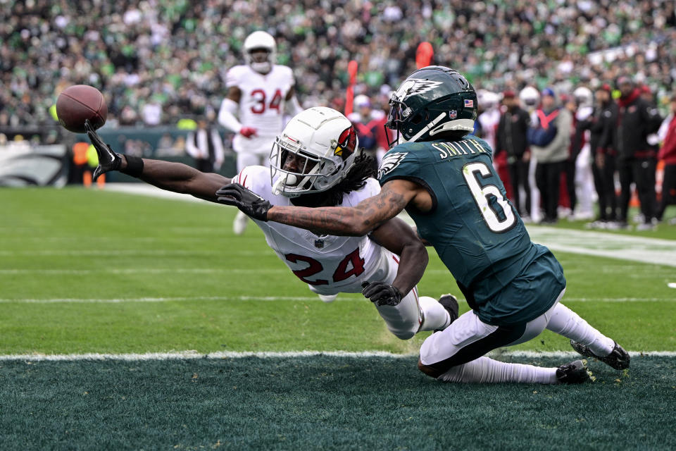Arizona Cardinals cornerback Starling Thomas V, left, breaks up a pass intended for Philadelphia Eagles wide receiver DeVonta Smith during the first half of an NFL football game, Sunday, Dec. 31, 2023, in Philadelphia. (AP Photo/Derik Hamilton)