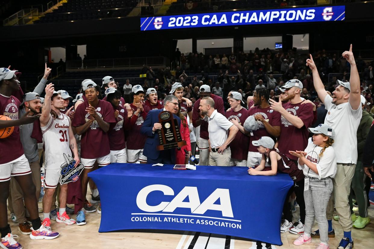 Colonial Athletic Association commissioner Joe D'Antonio presents Charleston Cougars head coach Pat Kelsey the conference championship trophy after defeating North Carolina-Wilmington Seahawks  at Entertainment & Sports Arena.