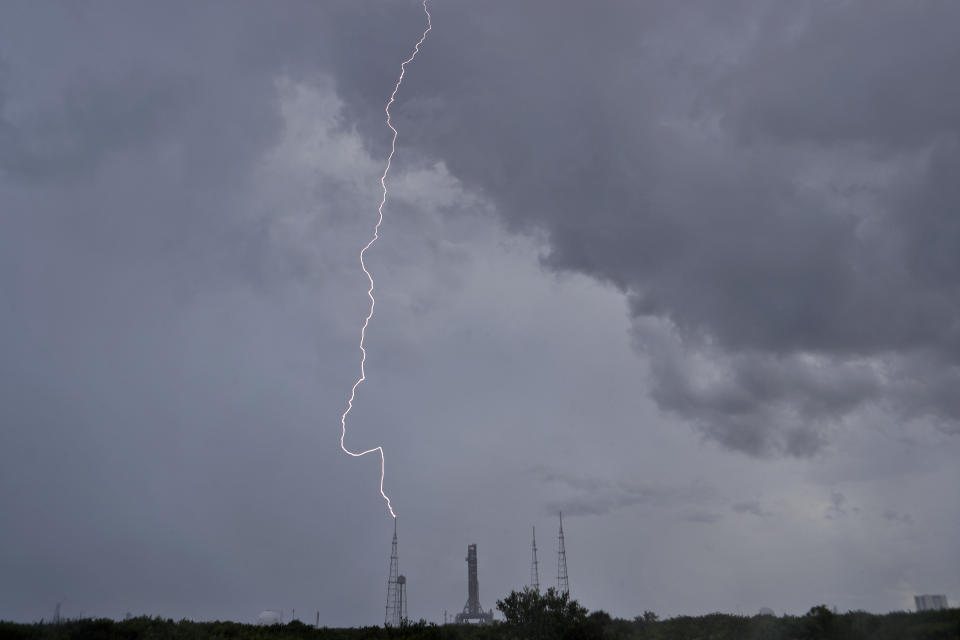 In this Saturday, Aug. 27, 2022 remote camera photo, a lightning bolt strikes near NASA's new moon rocket as she sits on Launch Pad 39-Bin Cape Canaveral, Fla. This is scheduled to be the first flight of NASA's 21st-century moon-exploration program, named Artemis after Apollo's mythological twin sister. (AP Photo/Chris O'Meara)