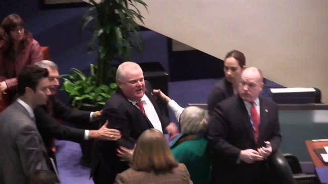 Toronto Mayor Rob Ford knocks over Councillor Pam McConnell at city Hall on Monday, Nov. 18, 2013. THE CANADIAN PRESS/Paola Loriggio