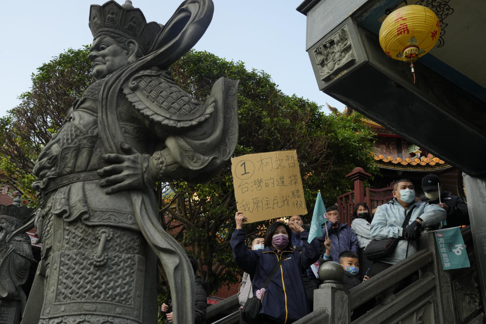 Supporters of Ko Wen-je, Taiwan People's Party (TPP) presidential candidate, look on as he visits a temple in New Taipei City, Taiwan on Wednesday, Jan. 10, 2024. With Taiwan's high-stakes presidential election just days away, the nonconformist candidate has been resonating with the island's youth, seemingly more concerned with the dearth of good jobs and affordable housing than the looming threat from China. (AP Photo/Ng Han Guan)