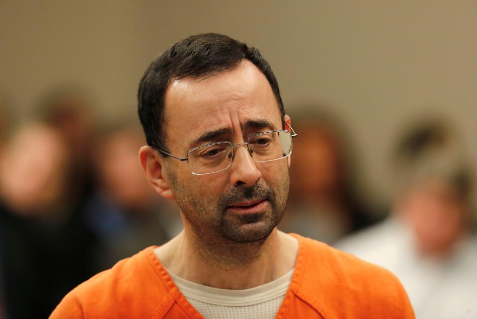 Dr. Larry Nassar appears in court for a plea hearing in Lansing, Mich.