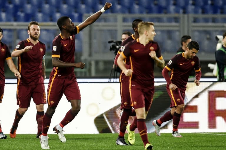 AS Roma's Antonio Rudiger (2to L) celebrates after scoring a goal against AC Milan during their Italian Serie A match, at Rome's Olympic stadium, on January 10, 2016