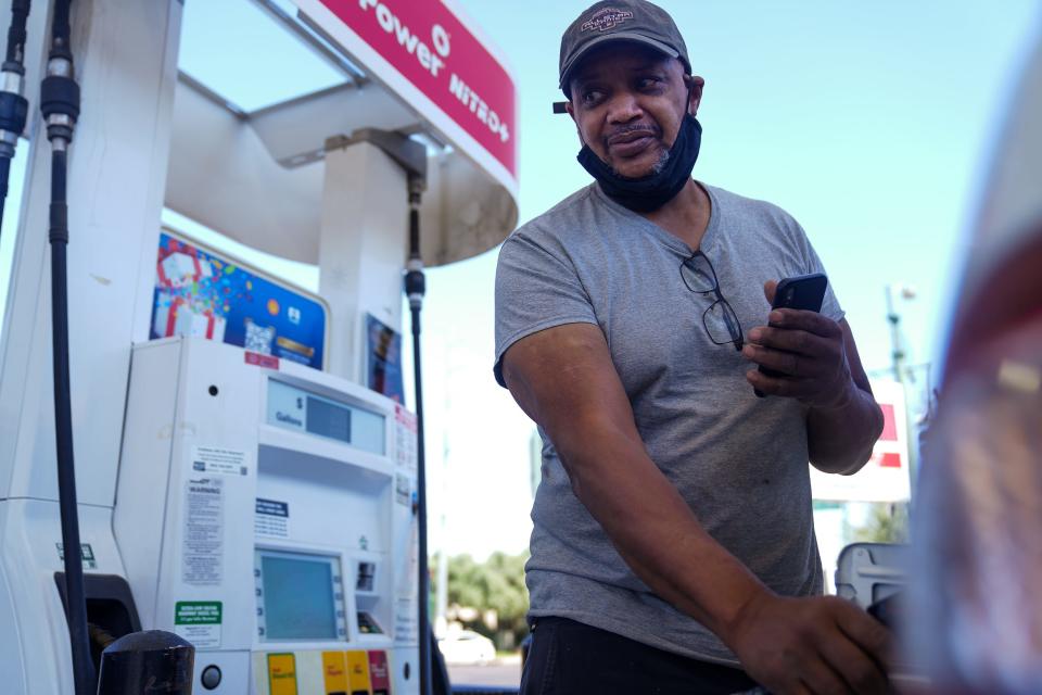 Jim Carson fills up his car with two gallons of gas for $15 at a Shell gas station on the corner of East Missouri Avenue and 12th Street in Phoenix on Friday, May 20, 2022.