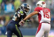 Nov 23, 2014; Seattle, WA, USA; Seattle Seahawks cornerback Richard Sherman (25) defends Arizona Cardinals wide receiver Michael Floyd (15) during the second half at CenturyLink Field. Seattle defeated Arizona 19-3. Mandatory Credit: Steven Bisig-USA TODAY Sports