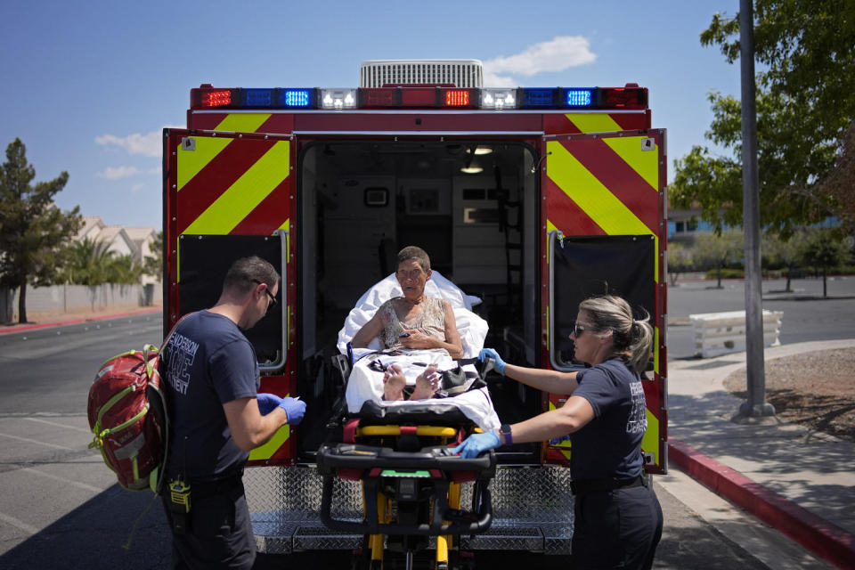 Members of the Henderson Fire Department load Deb Billet, 66, into an ambulance before transporting her to the hospital for heat-related symptoms, Wednesday, July 10, 2024, in Henderson, Nev. Billet has been living on the streets. (John Locher / AP)