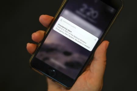 FILE PHOTO: A test text message of the Presidential Alert National Wireless Emergency Alert System is seen on a mobile phone in New York