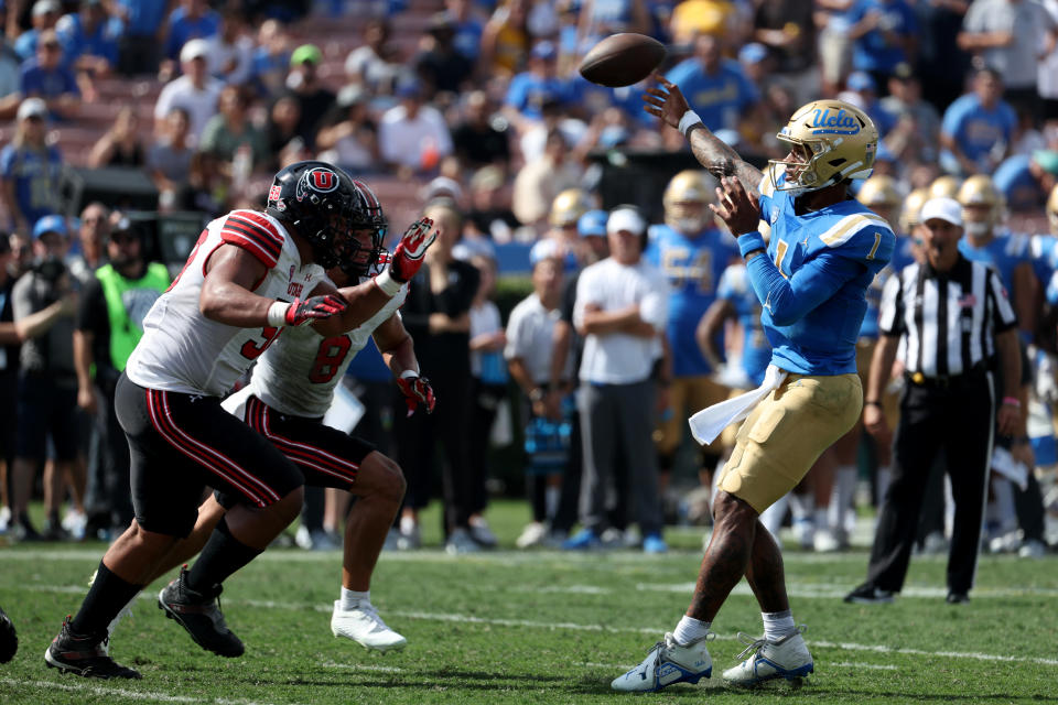 Oct 8, 2022; Pasadena, California, USA; UCLA Bruins quarterback <a class="link " href="https://sports.yahoo.com/nfl/players/40195" data-i13n="sec:content-canvas;subsec:anchor_text;elm:context_link" data-ylk="slk:Dorian Thompson-Robinson;sec:content-canvas;subsec:anchor_text;elm:context_link;itc:0">Dorian Thompson-Robinson</a> (1) throws a pass against Utah Utes defensive tackle Junior Tafuna (58) and safety Cole Bishop (8) during the second quarter at Rose Bowl. Mandatory Credit: Kiyoshi Mio-USA TODAY Sports