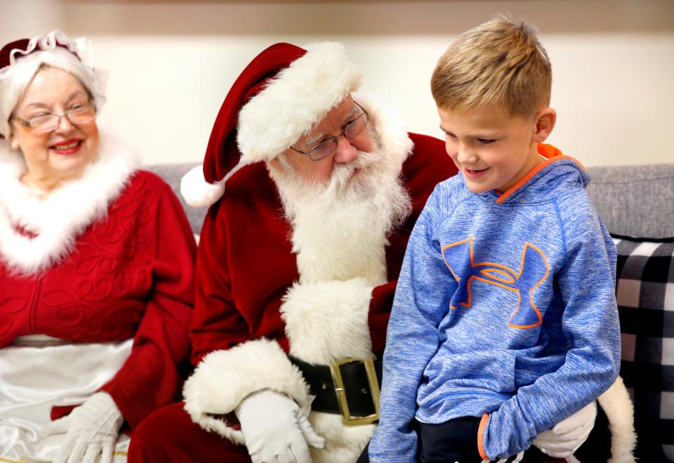 Ellis Anglin talks with Santa Claus during the 2021 Santa on a Fire Truck community outreach event at Acts II United Methodist Church in Edmond. (Credit: SARAH PHIPPS/THE OKLAHOMAN)