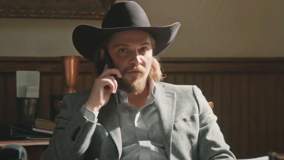 Luke Grimes as Kayce on the phone in Yellowstone.
