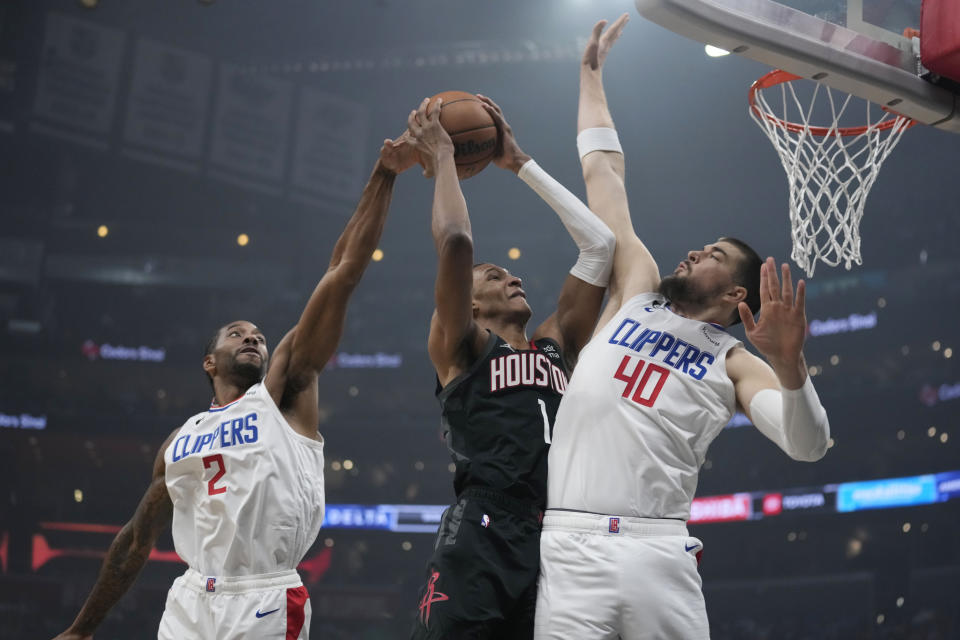 Houston Rockets forward Jabari Smith Jr. (1) is fouled by Los Angeles Clippers center Ivica Zubac (40) as he drives to the basket during the first half of an NBA basketball game, Sunday, Jan. 15, 2023, in Los Angeles. (AP Photo/Marcio Jose Sanchez)