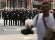 <p>Protesters face off with riot police escorting conservative activists following a march in Boston against a planned ‘Free Speech Rally’ just one week after the violent ‘Unite the Right’ rally in Virginia left one woman dead and dozens more injured on August 19, 2017 in Boston Mass. (Photo: Spencer Platt/Getty Images) </p>