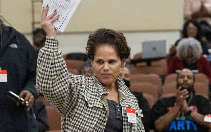 Dawn Basciano holds up legal documents while speaking during public comments at the California Reparations Task Force meeting, Wednesday, March 29, 2023, in Sacramento, Calif. She said her ancestors had land in Coloma taken by the state parks system. - Hector Amezcua/Sacramento Bee/via AP