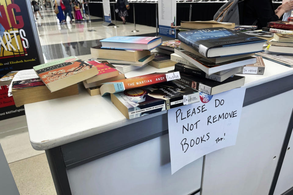 FILE - Banned books are stacked at an exhibit at the American Library Association's annual conference, June 24, 2023, at McCormick Place in Chicago. On New Year's Day, Monday, Jan. 1, 2024, Illinois will usher in 320 new laws, among them being the prohibition of banning books. Libraries that indiscriminately ban books will not be eligible for state funds. (AP Photo/Claire Savage, File)