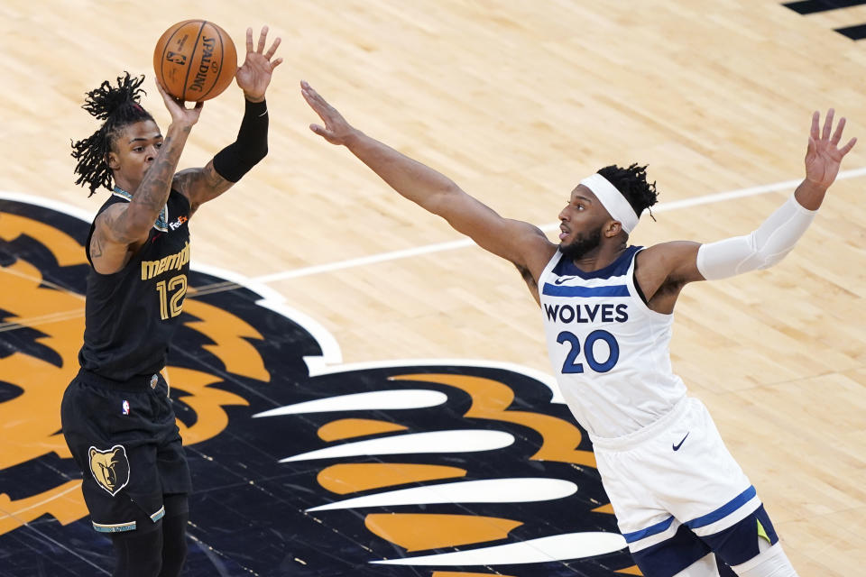 Memphis Grizzlies' Ja Morant (12) shoots over the reach of Minnesota Timberwolves' Josh Okogie (20) in the first half of an NBA basketball game Friday, April 2, 2021, in Memphis, Tenn. (AP Photo/Mark Humphrey)