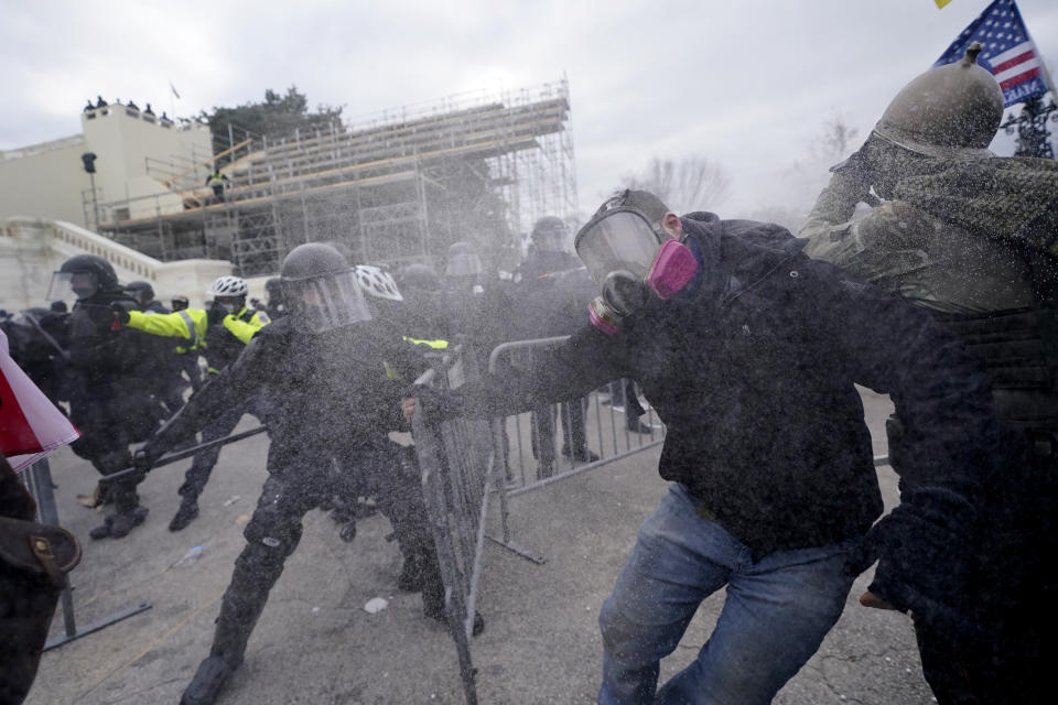 Trump supporters try to break through a police barrier, Wednesday, Jan. 6, 2021, at the Capitol in Washington. (AP Photo/Julio Cortez)