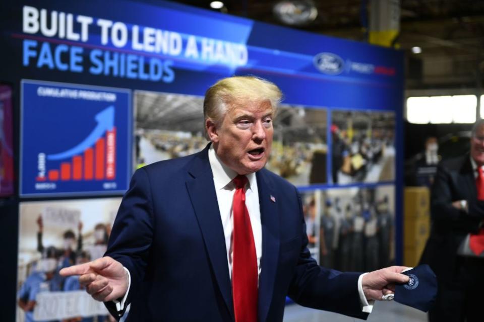 President Donald Trump holds a mask as he speaks during a tour of the Ford Rawsonville Plant in Ypsilanti, Michigan on May 21, 2020. | BRENDAN SMIALOWSKI/AFP—Getty Images