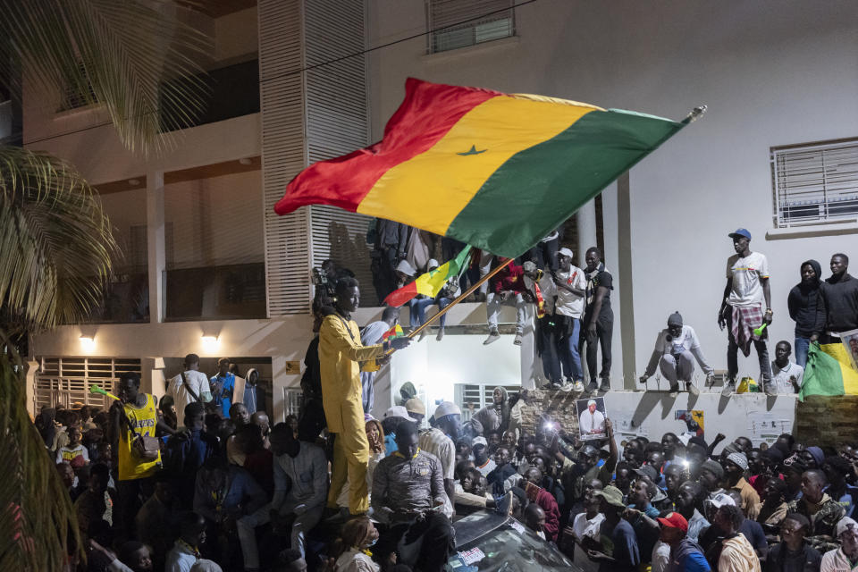 Supporters celebrate the release of Senegal's top opposition leader Ousmane Sonko and his key ally Bassirou Diomaye Faye outside Sonko's home in Dakar, Senegal, Thursday, March 14, 2024. Sonko had been in prison since July 2023 and has fought a prolonged legal battle to run for president in the March 24 election.(AP Photo/Sylvain Cherkaoui)