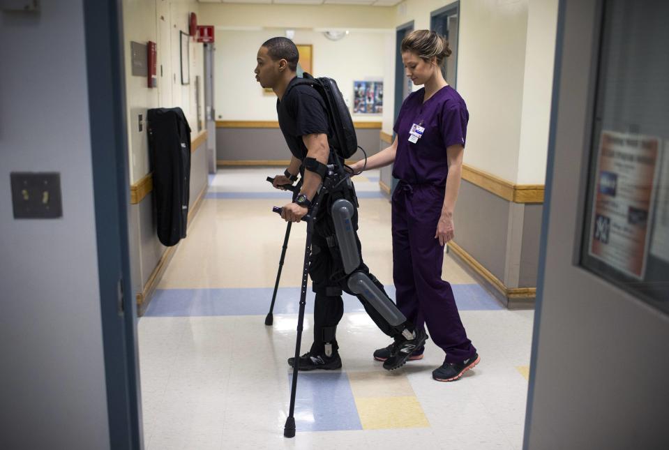 Samuels walks with a ReWalk electric powered exoskeletal suit during a therapy session with Voigt at the Mount Sinai Medical Center in New York City