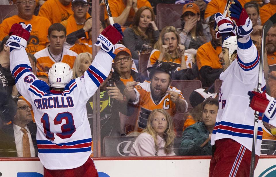 New York Rangers' Daniel Carcillo, left, celebrates his goal as he faces with fans with Brian Boyle, right, coming to him during the third period in Game 3 of an NHL hockey first-round playoff series, Tuesday, April 22, 2014, in Philadelphia. The Rangers won 4-1. (AP Photo/Chris Szagola)