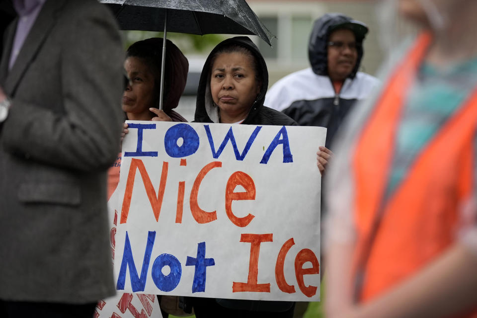 A woman listens to a speaker during an Iowa Movement for Migrant Justice rally and march, Wednesday, May 1, 2024, in Des Moines, Iowa. (AP Photo/Charlie Neibergall)