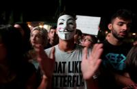 A demonstrator wears a mask during an anti-government protest in the southern city of Nabatiyeh