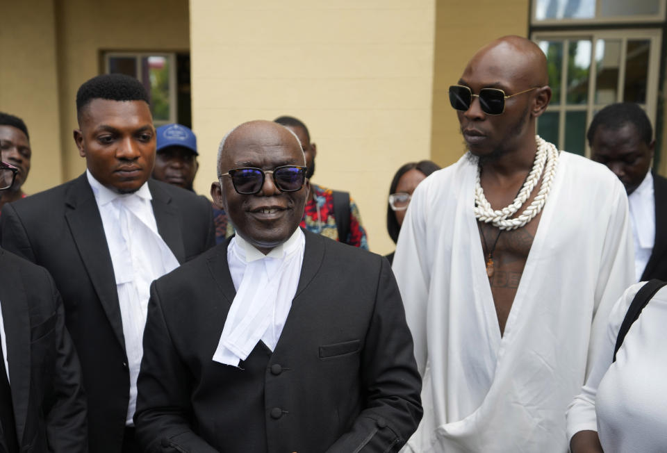 Afrobeat star, Seun Kuti, right, and his lawyer Femi Falana, center, leave the Magistrate court room after he was granted bail by a judge in Lagos, Nigeria, Wednesday, May 24, 2023. Kuti who is facing trial on charges of assaulting a police officer will embark on a delayed concert tour after being released on bail, his manager said Wednesday. (AP Photo/Sunday Alamba)