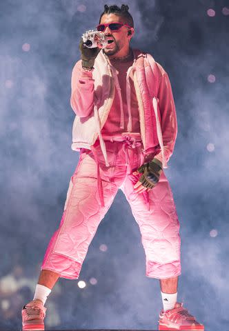 <p>Jason Koerner/Getty</p> Bad Bunny performs onstage during his El Ultimo Tour Del Mundo at FTX Arena in April 2022 in Miami, Florida.