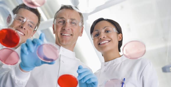 Scientists working together on samples in a lab.