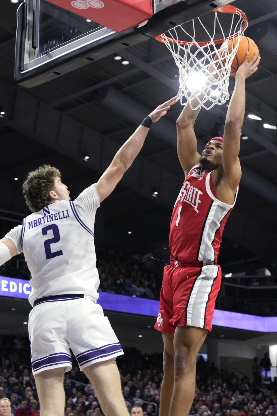 Ohio State guard Roddy Gayle Jr., right, goes up for a dunk against Northwestern forward Nick Martinelli (2) during the first half of an NCAA college basketball game in Evanston, Ill., Saturday, Jan. 27, 2024. (AP Photo/Nam Y. Huh)