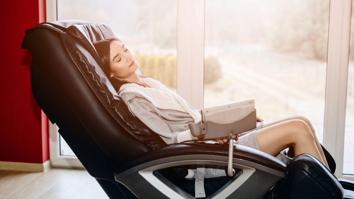 young woman relaxing on the massaging chair