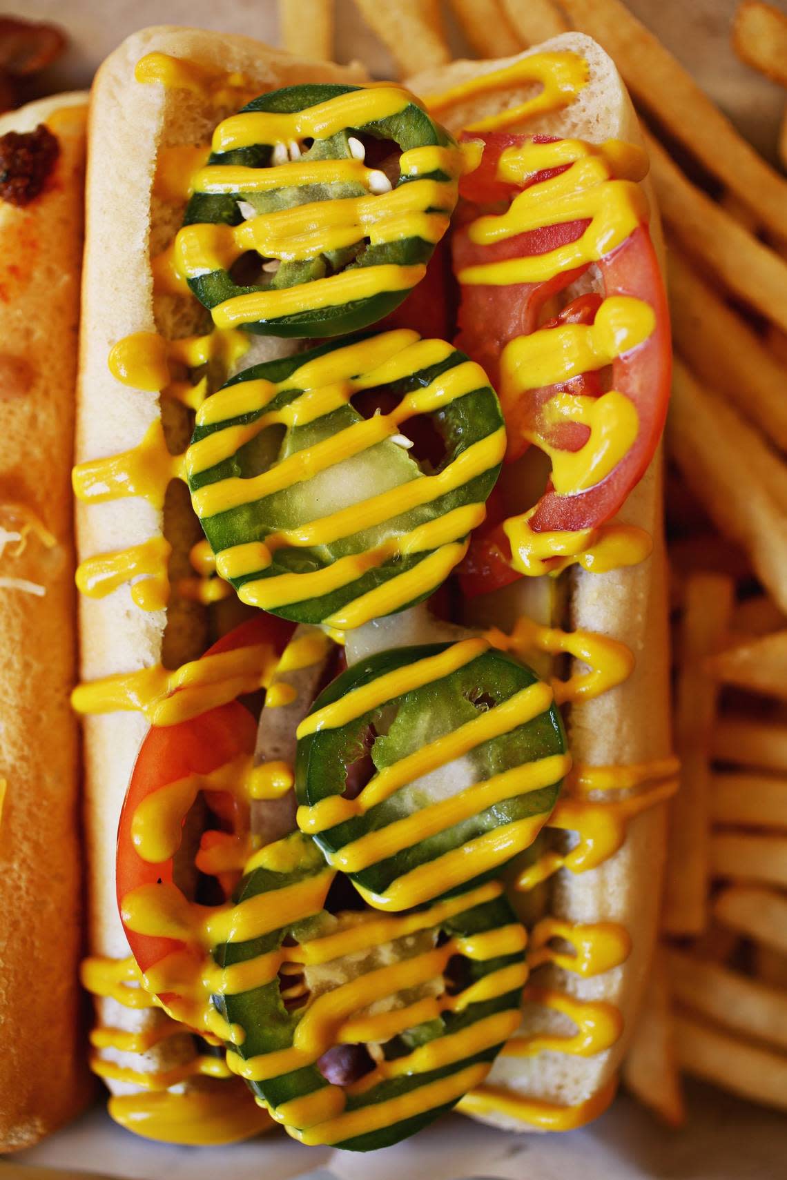 The Chicago Dog and Smokehouse Dog are served with fries at Chapel Hill’s Sup Dogs on Thursday, June 21, 2018.